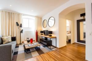 a living room with a couch and a table at Sound of Music World Appartement in Salzburg