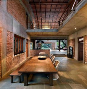 a large dining room with a wooden table and chairs at ama Stays & Trails The Mango House, Alibag in Alibaug