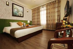 a hotel room with a large bed and a window at Golden Lotus Hotel & Spa in Hanoi