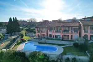 a large house with a swimming pool in front of it at Loft Diamante in Soiano del Lago
