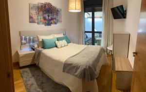 a bedroom with a large bed and a window at VIANA in Monforte de Lemos