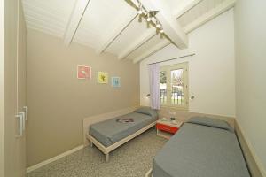 a bedroom with two beds and a window at Onda Blu Resort in Manerba del Garda +113 photos