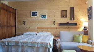 a bedroom with a bed and a chair at Luccia Apartments - Ohrid City Centre in Ohrid