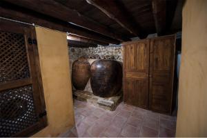 a room with two large vases in a building at Casa Rural EL TRULL in Canet lo Roig +34 photos