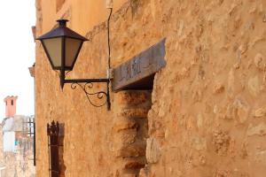 a street light attached to the side of a building at Casa Rural EL TRULL in Canet lo Roig