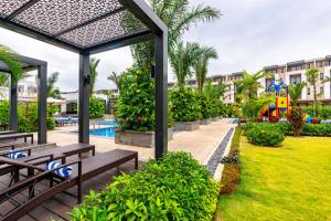 a resort with a pool and benches and a playground at Villa 102 royal lotus, Hùng Thắng, Hạ Long, Quảng Ninh in Ha Long