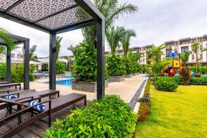 a resort with a pool and benches and a playground at Villa 102 - villa 114 royal lotus, Hùng Thắng, Hạ Long, Quảng Ninh in Ha Long
