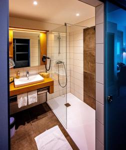 a bathroom with a glass shower and a sink at Hotel Hausschachen in Weitra