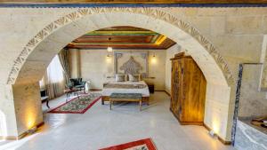 an archway in a bedroom with a bed and a table at Premium Cappadocia House in Goreme