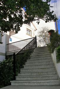 a row of stairs leading up to a balcony at Hostal Santa Marta Playa in Baiona