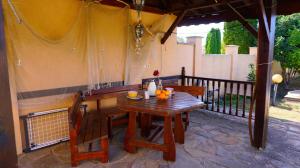 a wooden table and chairs on a patio at Вила Матилда - Villa Matilda in Bŭlgarevo