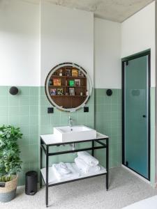 a bathroom with a sink and a mirror at JOST Hôtel Bordeaux Centre Gare Saint Jean in Bordeaux