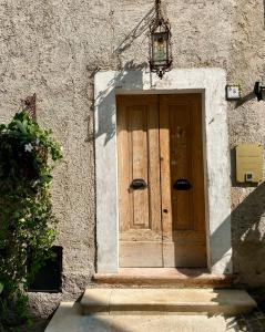 a wooden door in the side of a building at Casa L'Andrunèl in Limone sul Garda