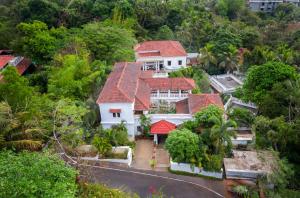 an aerial view of a white house with red roofs at amã Stays & Trails Villa No 1, Goa in Old Goa