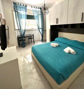 a bedroom with a bed with two towels on it at Quiet & Cosy Colosseum in Rome