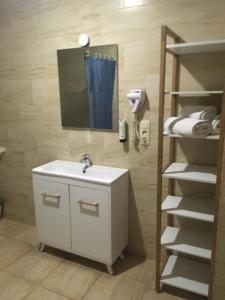 a bathroom with a sink and a phone on the wall at Albert Hotel in Brussels