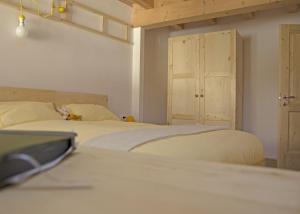 a bedroom with two beds and a closet and a door at Le Castagne Matte in Stenico