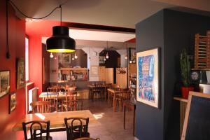 a restaurant with tables and chairs and a dining room at Logis Les 7 Frères in Monestier-de-Clermont