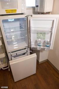 an open refrigerator with two bottles of water in it at Nanei Building - Vacation STAY 04905v in Kagoshima