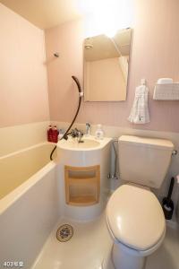 a bathroom with a toilet and a sink and a tub at Nanei Building - Vacation STAY 04905v in Kagoshima