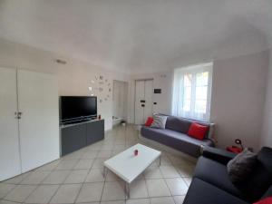 a living room with a couch and a table at La Dimora del Sole in Finale Ligure