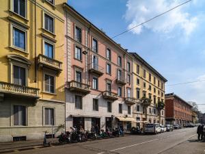 a row of buildings with motorcycles parked on a street at Brera - San Marco Cozy Apartment in Milan