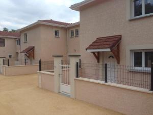 una fila de casas con una puerta y una valla en klm, en Roussillon en Isère