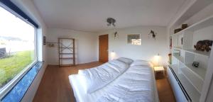 a bedroom with a bed and a large window at Family Friendly Apartment, Garden, 900m LegoHouse, Lalandia, Legoland in Billund