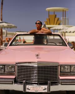 een man achterin een roze auto bij Grand Paradiso Ibiza - Adults Only in San Antonio Bay