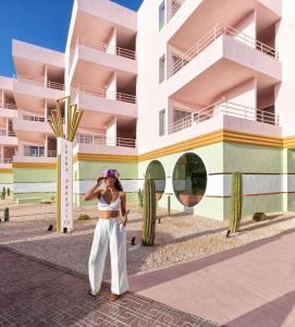 een vrouw die voor een gebouw staat bij Grand Paradiso Ibiza - Adults Only in San Antonio Bay