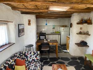 a kitchen with a couch and a table in a room at El Huarango Eco Lodge in La Huaica