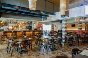 a restaurant with tables and chairs and a bar at Alfagar Village in Albufeira