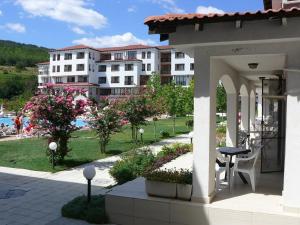 a patio with a table and a view of a building at Harmony Hills Poseidon in Rogachevo