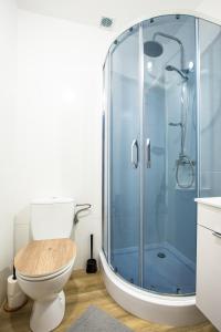 a bathroom with a toilet and a glass shower at WillaMaks in Ustka