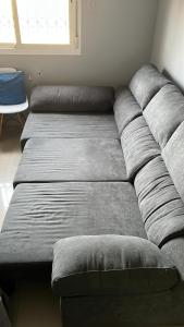 a large gray couch sitting in a room at El nido del nómada in Atarfe