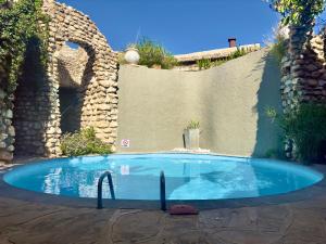 a swimming pool in a yard with a stone wall at Onjala in Eorondemba