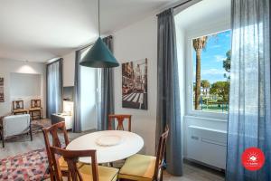 a dining room with a table and chairs and a window at Wild Zagara Luxury Sea View in La Spezia