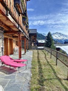 a house with a pink picnic table outside of it at Residence Bastide in Verbier