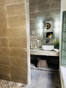 a bathroom with a sink and a mirror at Riad Villa Wengé & Spa in Marrakech