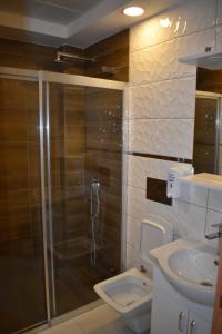 a bathroom with a shower and a toilet and a sink at Terko hotel pansiyon in Beldibi