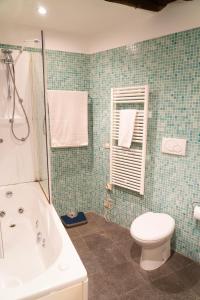 a bathroom with a tub and a toilet and a sink at Martina Guest House in Genova +19 photos