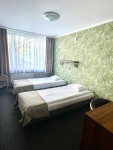Posteľ alebo postele v izbe v ubytovaní Hotel Mazowiecki Łódź