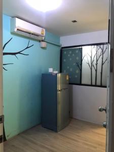 a room with a refrigerator and a window at Rod Fai Fah Apartment in Bangkok