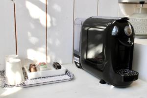 a toaster oven sitting on a counter next to a candle at Fleur de Ré in Loix