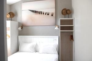 a bedroom with a bed and a wall with a gun on it at Fleur de Ré in Loix