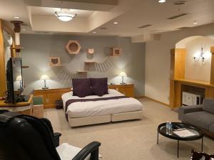 a bedroom with a bed and a living room at ORDA HOTEL in Chiba