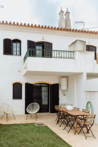 a patio with a table and chairs in front of a building at Altura Beach Villa by GT House in Altura