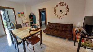 a living room with a couch and a table and a clock at Parco della danza in Reggio Emilia