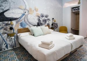 una camera da letto con un grande letto con asciugamani di Casa Rural Casa Levante ad Arcos de la Frontera