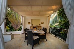 a dining room with a table and chairs at ama Stays & Trails 70 Vale, Goa in Vagator